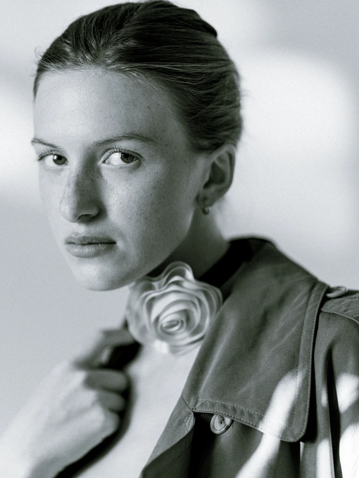 Monochrome close-up portrait with a flower detail